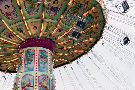 Vienna, Austria - January 01, 2018: Side view of the spinning Luftikus carousel or chain swing ride at overcast day, Prater amusement parkのeditorial素材