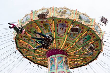 Vienna, Austria - January 01, 2018: Low angle view of the moving Luftikus carousel or chain swing ride at overcast day, Prater amusement parkのeditorial素材