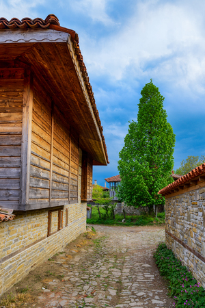 Narrow cobbled street in Zheravna, Bulgaria - architectural reserve of rustic houses from the Bulgarian national revival periodの写真素材