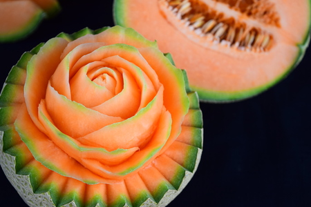 Juicy carving and half cut honeydew melon isolated on white backgroundの写真素材