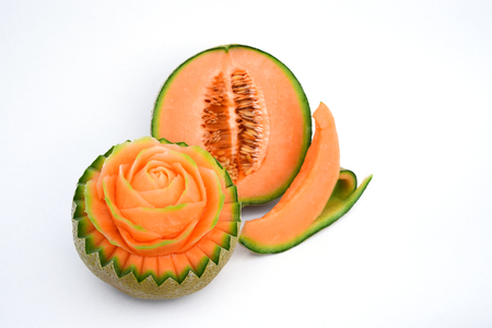 Juicy carving and half cut honeydew melon isolated on white backgroundの写真素材