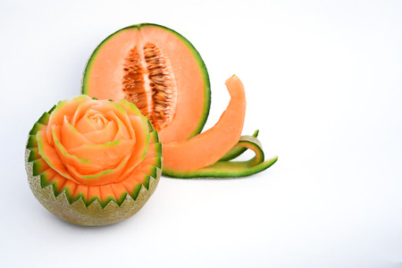 Juicy carving and half cut honeydew melon isolated on white backgroundの写真素材