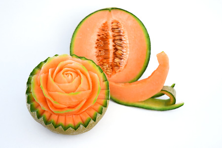 Juicy carving and half cut honeydew melon isolated on white backgroundの写真素材