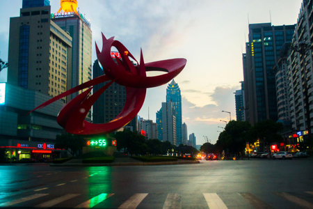 A sculpture sits at the center of a major street in Suzhou, Chinaのeditorial素材