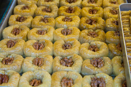 Eastern sweets baklava round with walnuts topped with honeyの写真素材