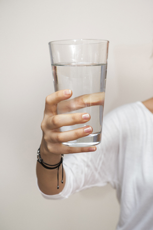 hand holding a glass of waterの写真素材