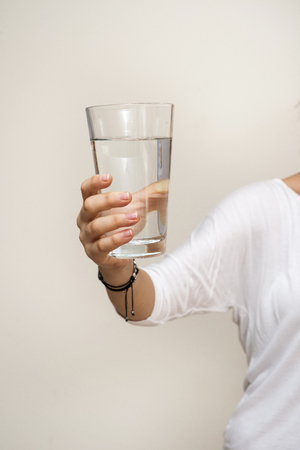 hand holding a glass of waterの写真素材