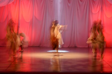 Whirling Dervishes in white and in a religious trance performing on a Turkish stage.の写真素材