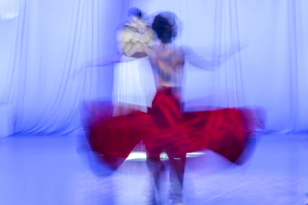 Whirling Dervishes in white and in a religious trance performing on a Turkish stage.の写真素材