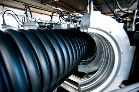 Bunches of PVC pipe sitting on palets at a wholesale pipe store.の写真素材