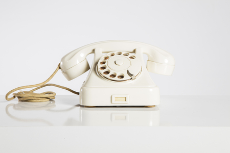 Old telephone isolated on whiteの写真素材