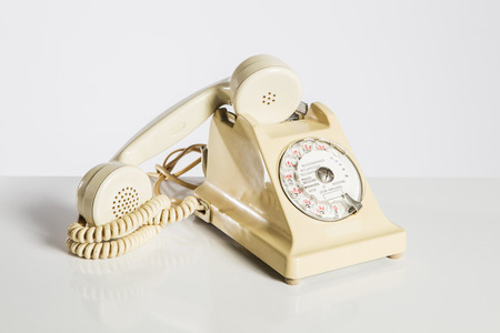 Old telephone isolated on whiteの写真素材