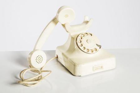 Old telephone isolated on whiteの写真素材
