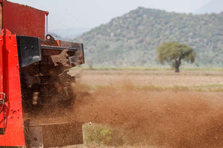 Agricultural scene of farmer manure spreading as agricultural background. Fertilising the field.の写真素材
