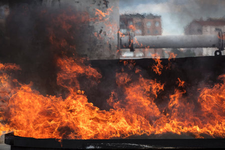 Burning fire in the city. Firefighters extinguish the fire.