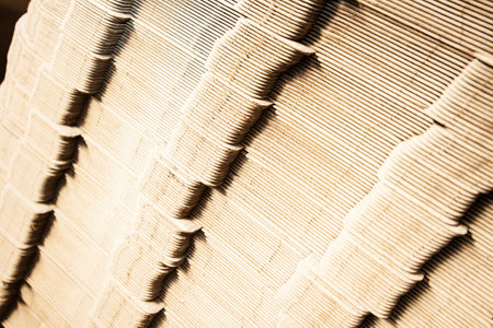 Close up of a stack of corrugated cardboard in a warehouseの写真素材