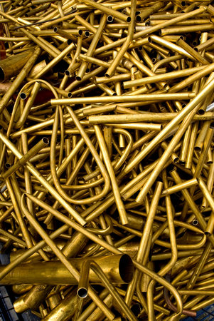 A lot of golden metal pipes in a shop, closeup of photo