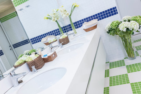 Bathroom interior with sink, faucet and flower decorationの写真素材