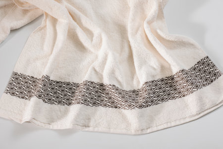 White towel with a pattern on a white background close-up.の写真素材