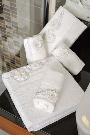 Towels on a black countertop in a bathroom, close-upの写真素材