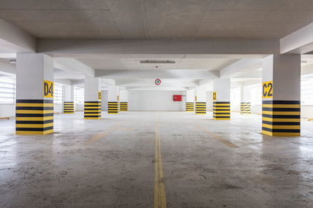 Parking garage interior with yellow and black stripes, underground car parkingの写真素材