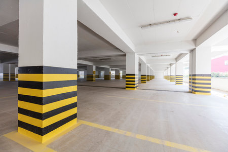 Parking garage interior with yellow and black stripes, under construction.の写真素材