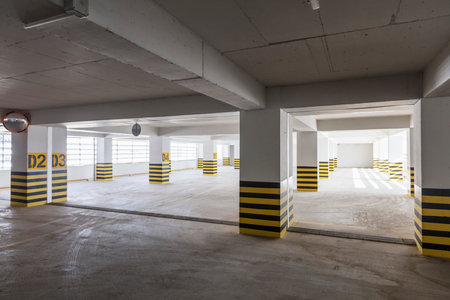 Interior of an empty car park with yellow and black stripes.の写真素材