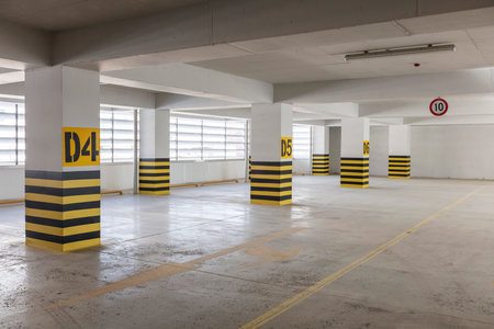 Parking garage interior with yellow and black stripes, underground parking.の写真素材