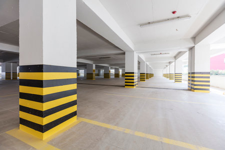 Interior of a parking lot with yellow and black stripes, underground parkingの写真素材