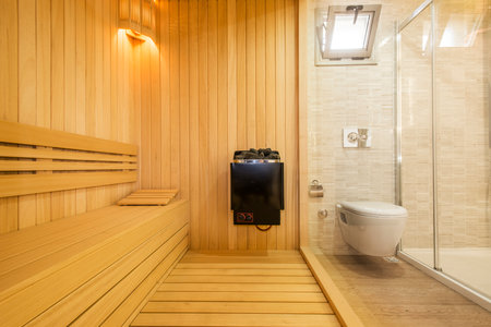Interior of a modern sauna with wooden walls and wooden floorの写真素材