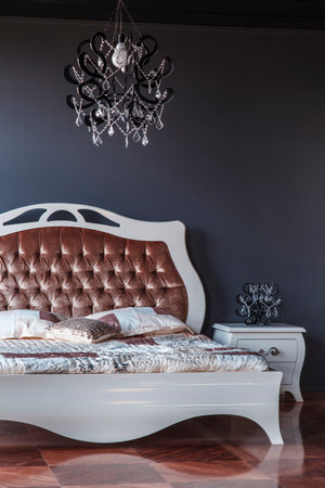 luxury bedroom interior in classic style with brown leather bed and black wallの写真素材