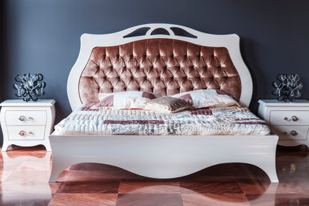 luxury bedroom interior in classic style with wooden bed and bedside tableの写真素材