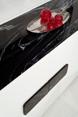 Interior of a modern kitchen with black marble countertop and mirrorの写真素材