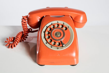 Old red telephone on a white background. Vintage telephone. Retro telephone.の写真素材