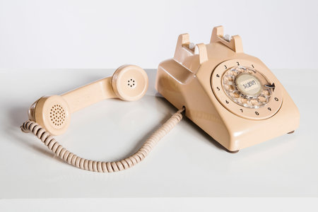 Vintage telephone on a white background with copy space for your textの写真素材