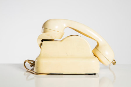 Retro telephone on a white background with reflection and space for textの写真素材