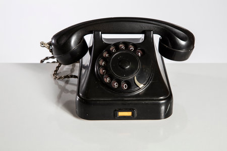 Old black telephone on a white background. Isolated with clipping pathの写真素材