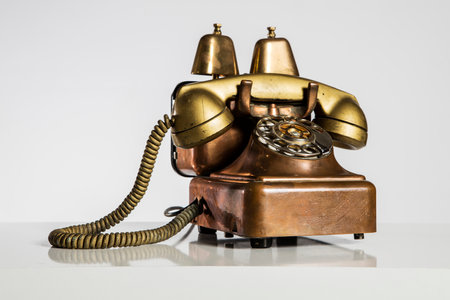Vintage telephone on a white background with reflection and copy space.の写真素材