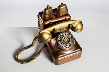 Vintage telephone on a white background. Old telephone on a white background.の写真素材