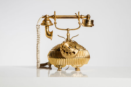Vintage telephone on a white background with reflection and copy space.の写真素材