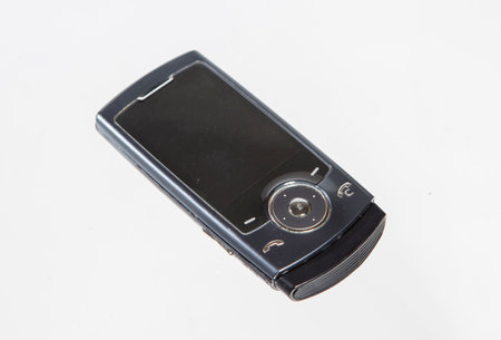 old mobile phone isolated on a white background, closeup of photoの写真素材