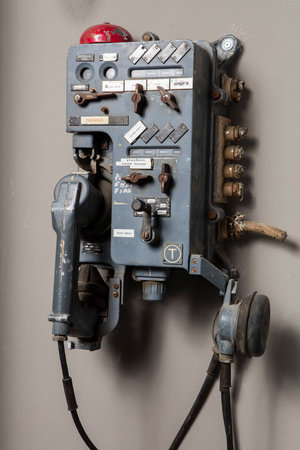 Vintage telephone on a white wall. Vintage telephone on a white wallの写真素材
