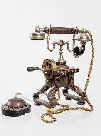 Vintage telephone on a white background with a chain in the foregroundの写真素材