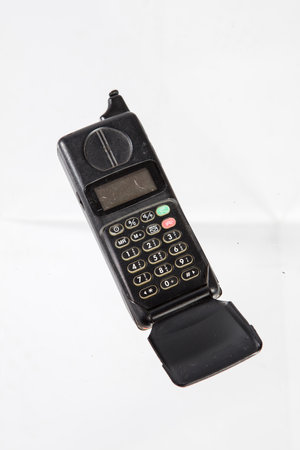 Old mobile phone on a white background, closeup of photo.の写真素材
