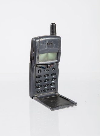Old black mobile phone isolated on white background, with clipping path.