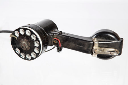 Old black phone isolated on white background. Vintage telephone. Retro telephone.の写真素材