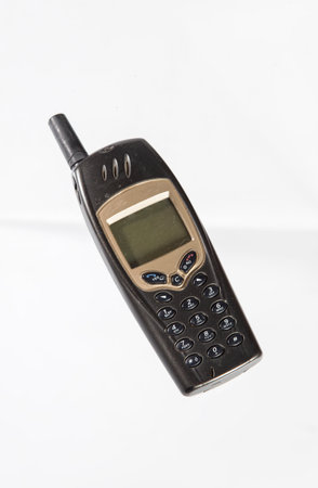 Old phone isolated on a white background. Old style mobile phone.の写真素材
