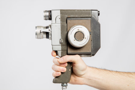 Old camera in the hands of a man on a white background.の写真素材