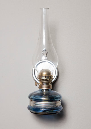 Old kerosene lamp on a gray background with space for textの写真素材