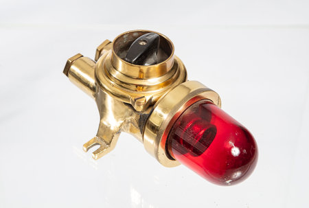 close-up of a red light on a white background with reflectionの写真素材